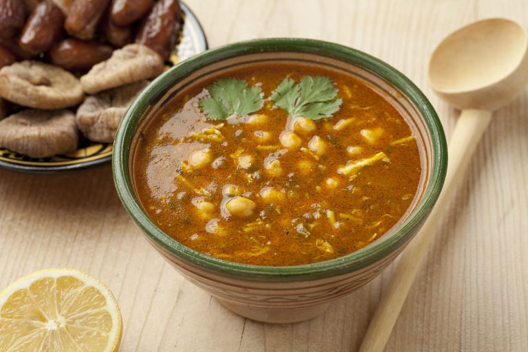 bowl of Moroccan harira soup in traditional bowl. Served with dates and dried figs.