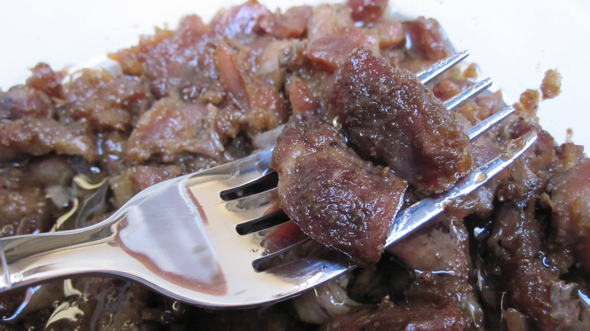 Mqila dish: image showing a fork holding small pieces of meat from a Moroccan dish called Mkila