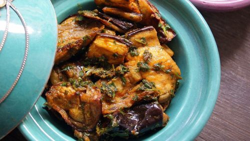 A small tagine filled with oven-roasted chunks of eggplant marinated in chermoula.