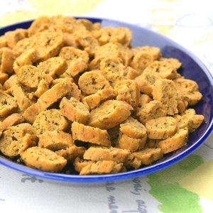 Moroccan petite fekkas with chermoula on a plate. They are bite-sized savory cookies which are baked twice like biscotti.