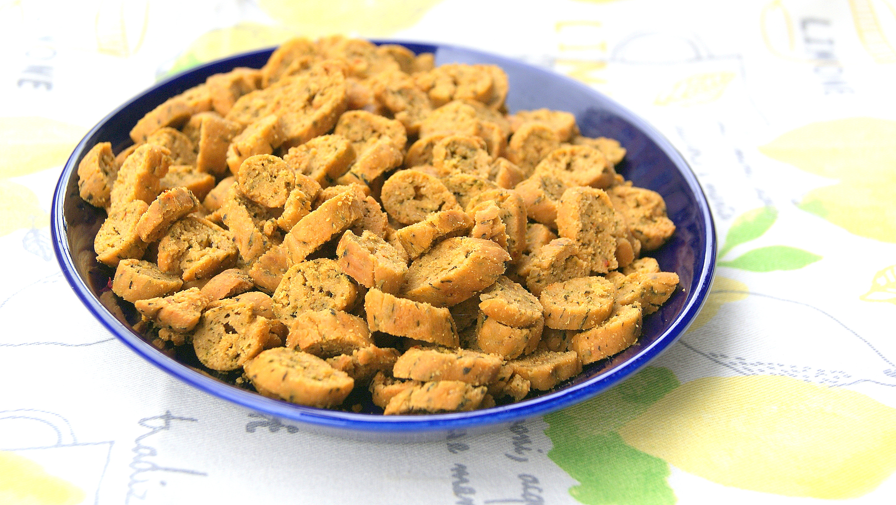 Moroccan petite fekkas with chermoula on a plate. They are bite-sized savory cookies which are baked twice like biscotti.