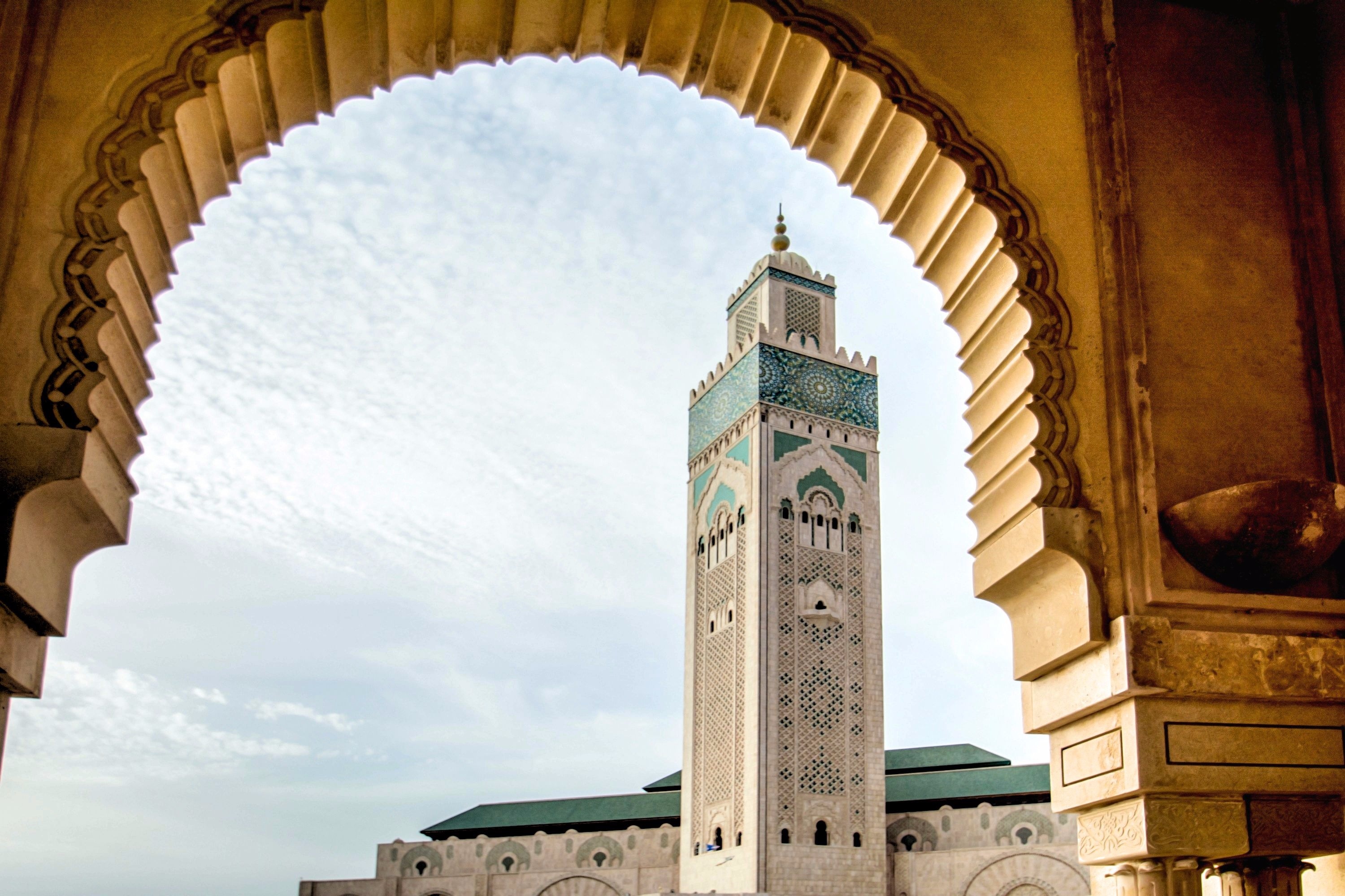 A view through an arch of the minaret of Hassan II mosque in Casablanca.