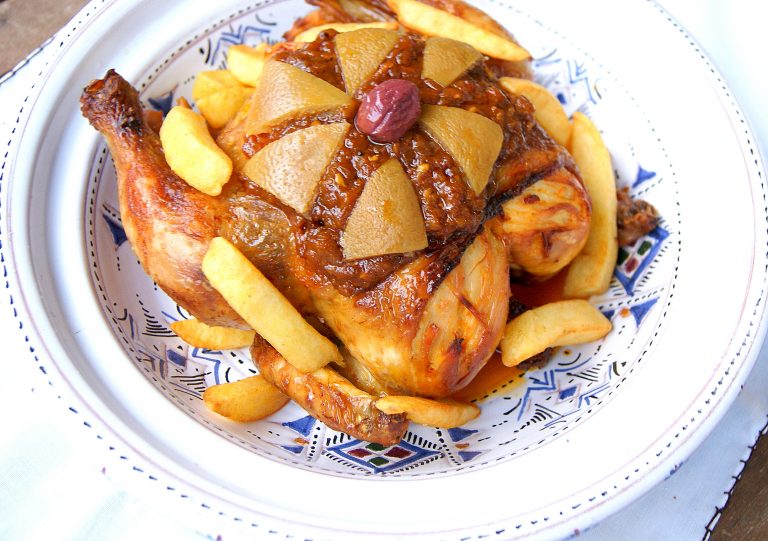 Moroccan chicken m'hammar topped with onion sauce, preserved lemons, purple olive and fried potatoes