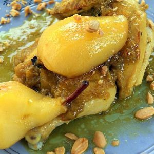 A serving of Moroccan chicken and caramelized pears garnished with fried almonds.