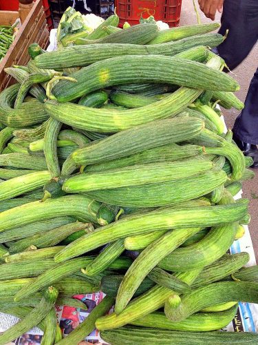 A pile of bendy cucumber in a market