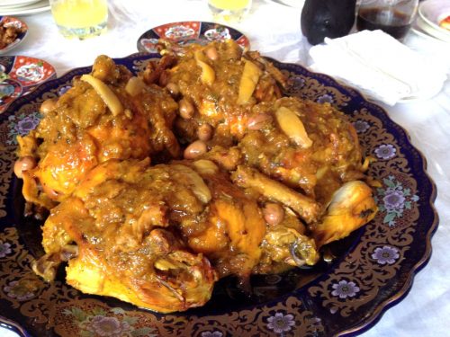 A roasted chicken was cooked m'qualli style with a thick onion sauce, preserved lemons and olives.