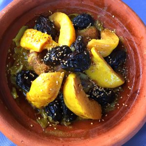 Moroccan tagine with lamb, quinces and prunes, cooked m'qualli-style and sprinkled with sesame seeds