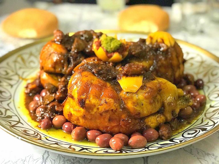 Moroccan chicken m'qualli. 3 chichens garnished with daghmira, olives and preserved lemons.