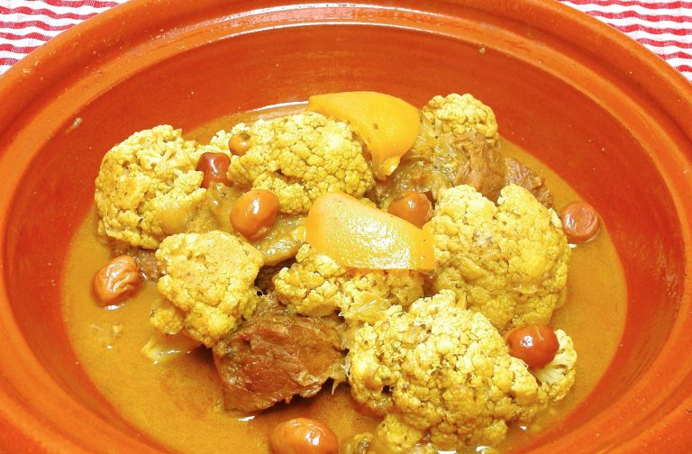 A Moroccan dish of beef and cauliflower with preserved lemon and olives in the base of a tagine.