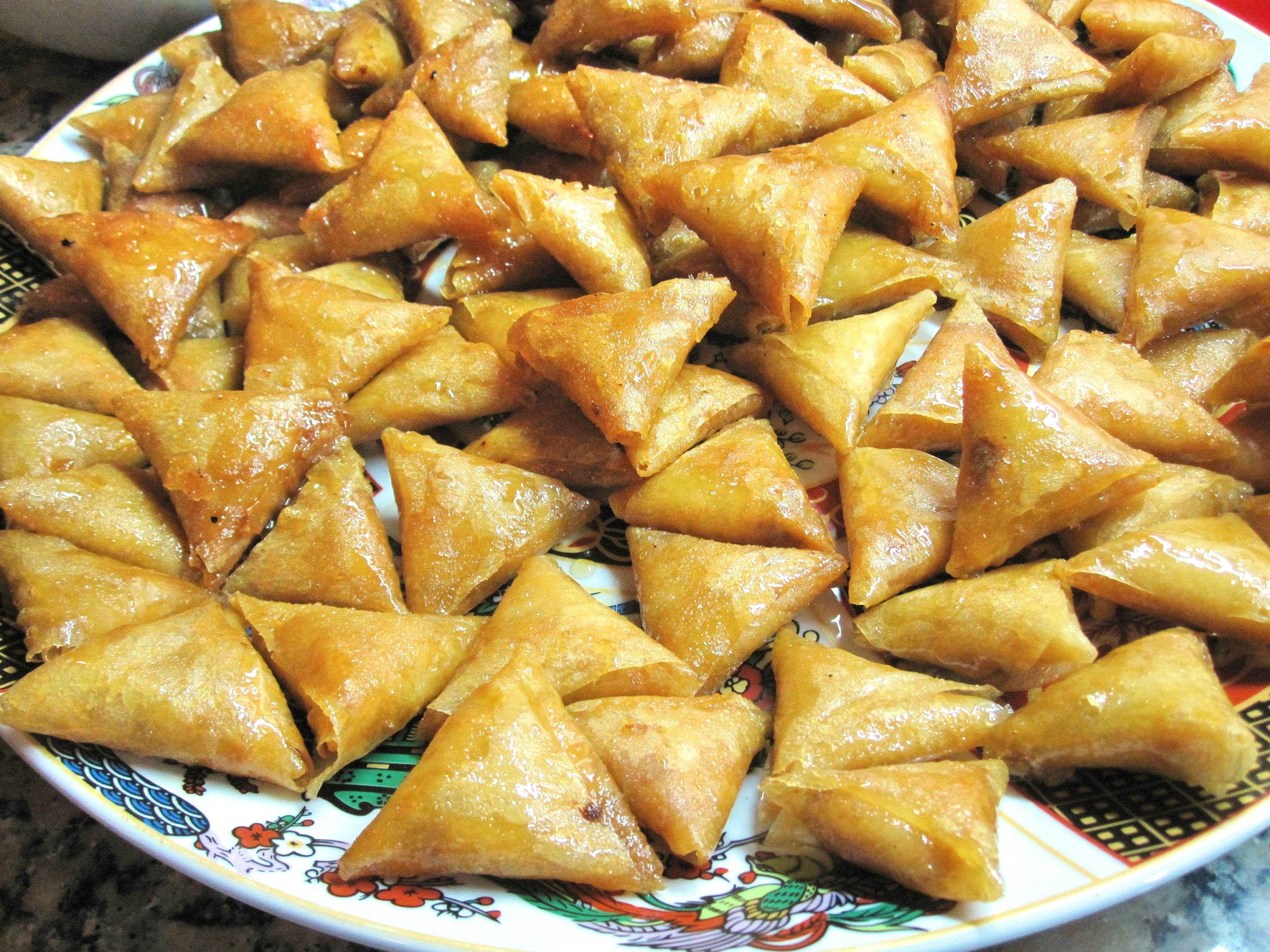 A platter of almond briouats, a Moroccan triangular shaped pastry filled with almond paste.